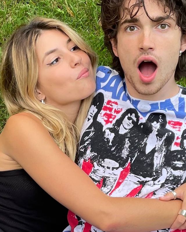 Elijah Hewson in a printed t-shirt with his girlfriend in a black sleeveless.